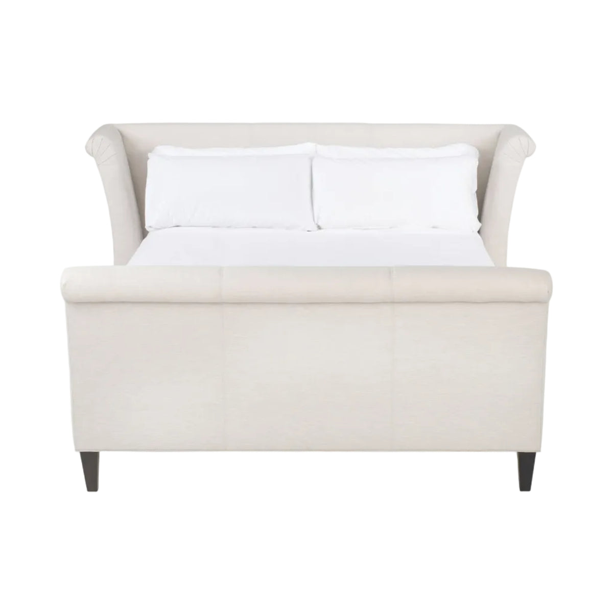 White upholstered bed with white bedding on a white background