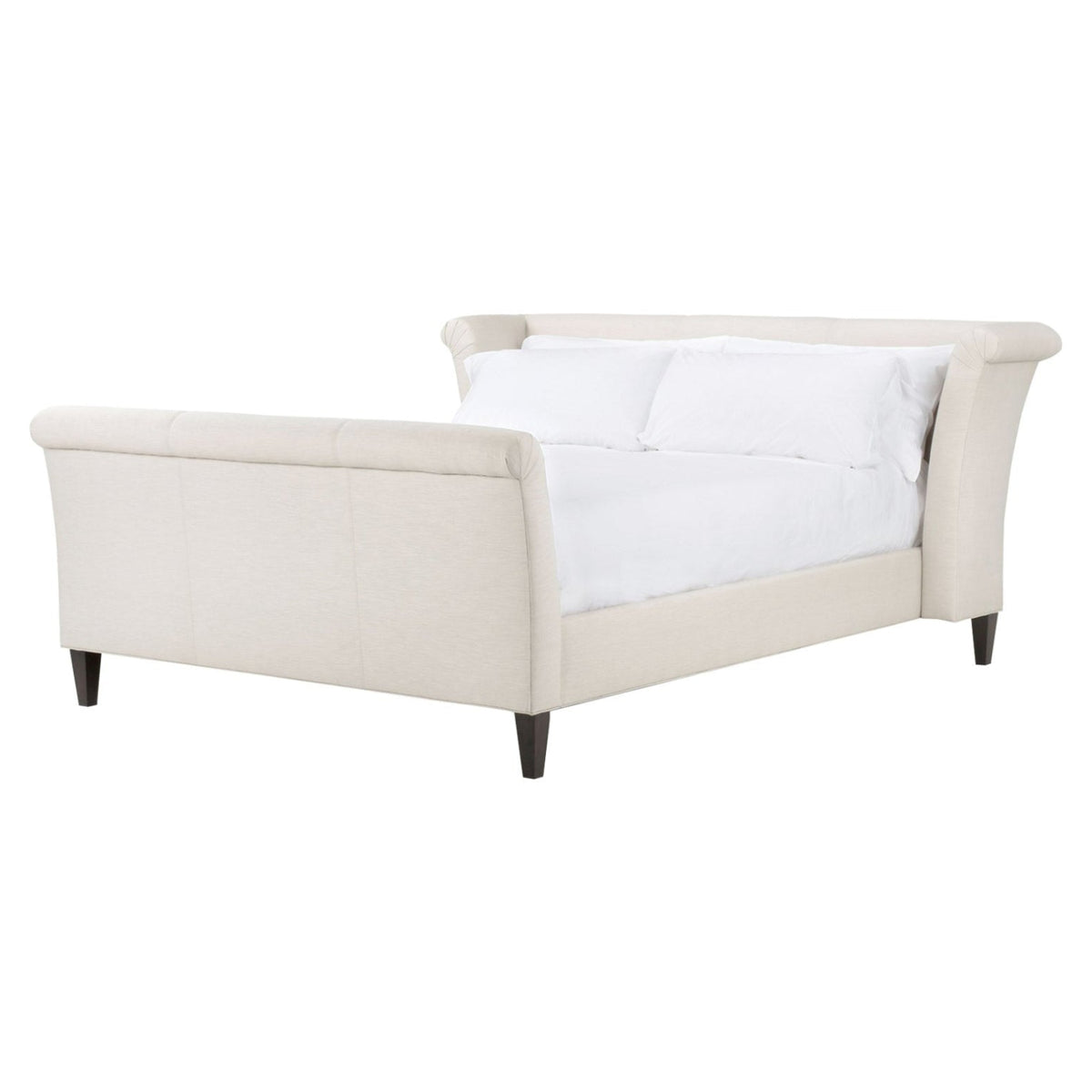Beige upholstered bed with white bedding on a white background