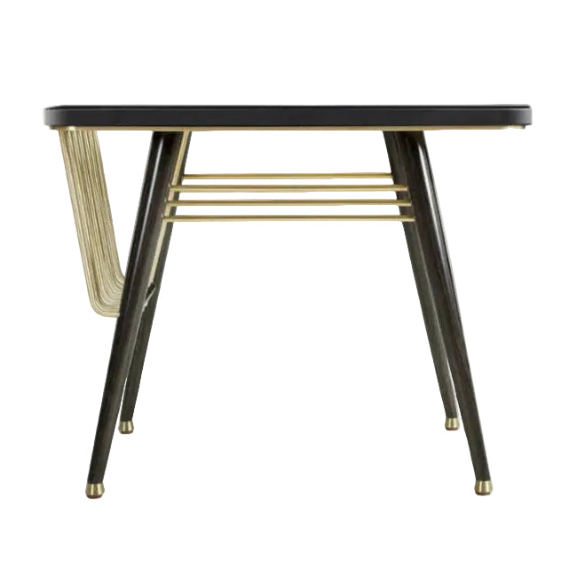 A modern side table with a black rectangular top, black tapered legs with gold caps, and gold metal wire accents on the side and under the tabletop, shown against a plain white background.