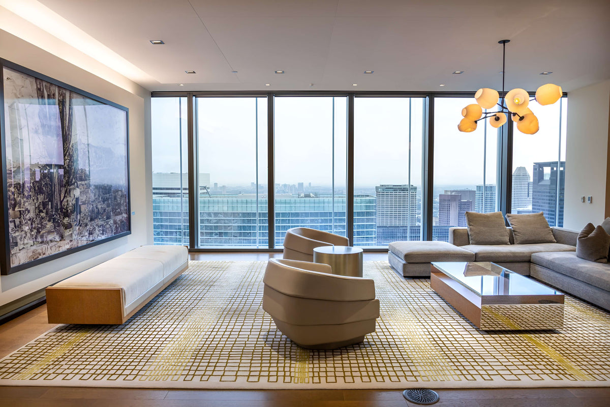 Modern living room with large windows, stylish furniture, and cityscape view.