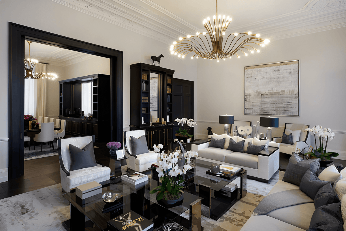 A luxury modern living room featuring a large gold multi-arm chandelier, black and white sofas, marble coffee tables, and elegant home decor.