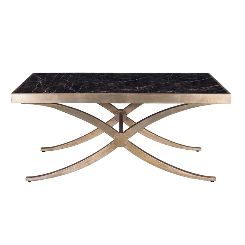 A rectangular coffee table featuring a black marble top with subtle gold veining and a curved, brushed gold metal base in an X-shaped design.