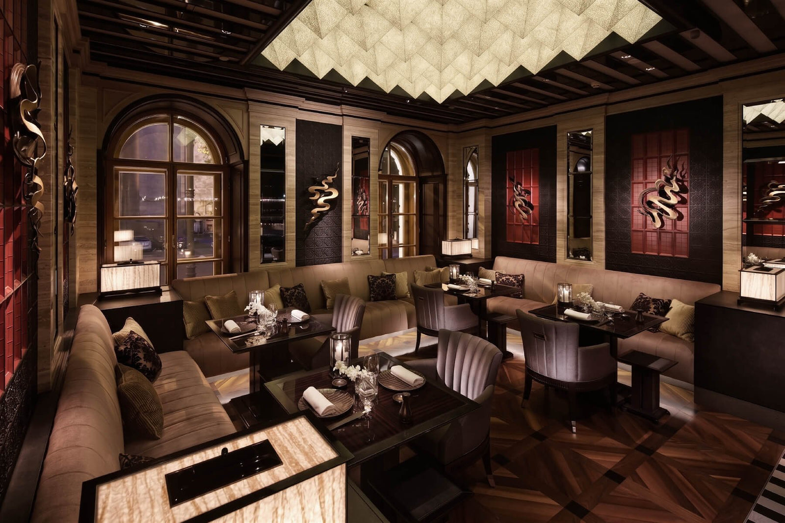 Luxurious interior of a restaurant with elegant decor and seating arrangements.