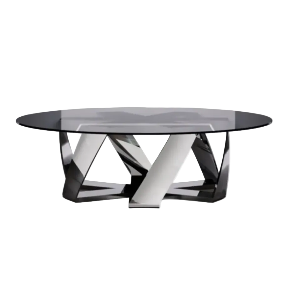A modern round coffee table with a black glass top and a sculptural chrome and black metal base, positioned in a contemporary living room setting between two black armchairs with silver legs, set against a large window overlooking a city skyline.