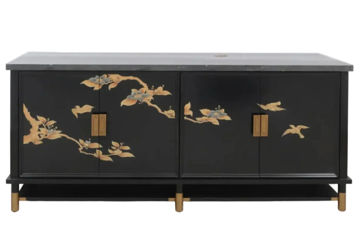 A black wooden sideboard cabinet with a dark gray stone top, featuring gold-painted bird and branch inlays on the doors and brass-toned hardware.