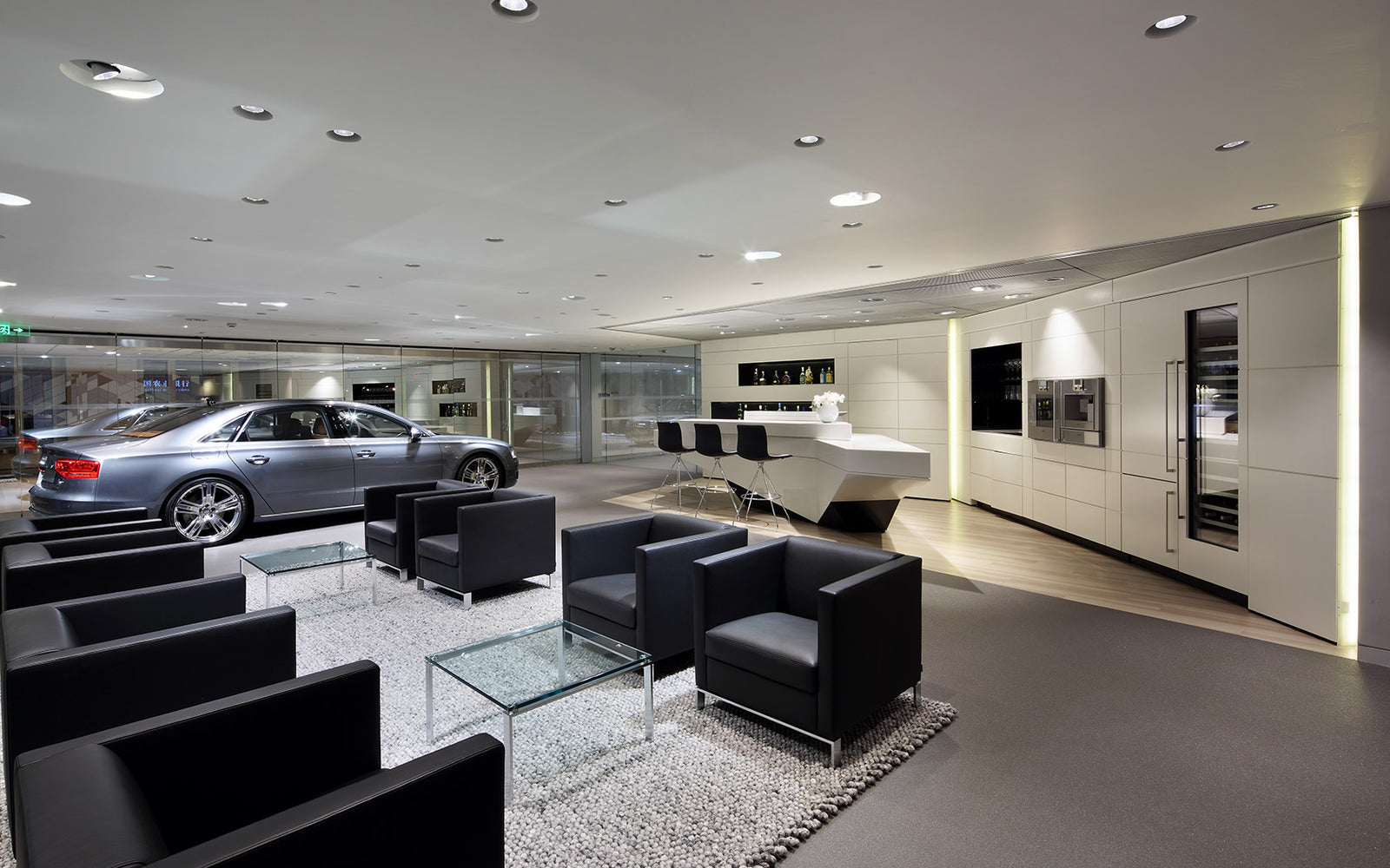 Modern interior of a showroom with cars, furniture, and appliances.
